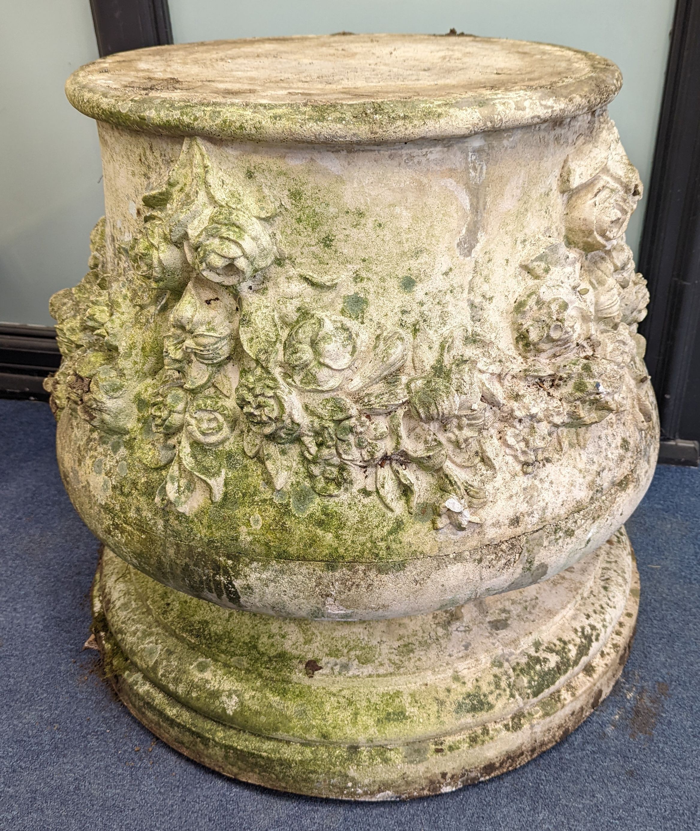 A pair of reconstituted stone garden pedestals, moulded with floral swags, height 66cm